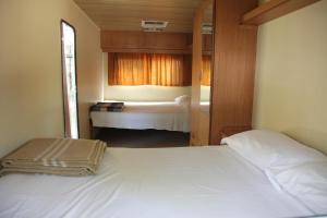 Ένα ή περισσότερα κρεβάτια σε δωμάτιο στο Camping Golfo dell'Asinara