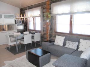 a living room with a couch and a table at Lapin Kutsu Log Cabins in Saariselka