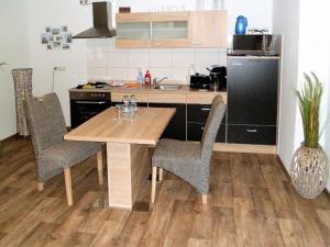 a kitchen with a wooden table and chairs at Ferienwohnung Anke - Apartment 3b in Heinsberg