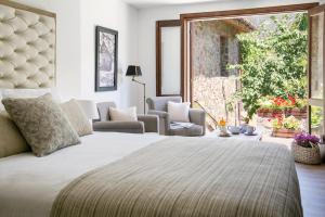 a bedroom with a large bed and a window at Casale Panayiotis in Kalopanayiotis