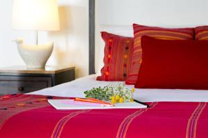 a plate of flowers and chopsticks on a bed at Casale Panayiotis in Kalopanayiotis