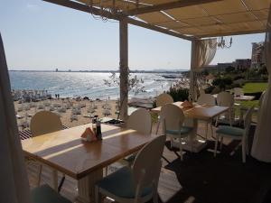 a restaurant with tables and chairs and a view of the beach at Private Apartment in Star Dreams Complex in Sveti Vlas