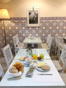 a table with food on it in a dining room at Pensao Central in Matosinhos