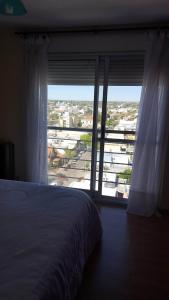 a bedroom with a bed and a large window at Edificio Catalina in Santa Rosa