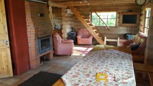 a living room with a couch and a fireplace at Oksa Puhkemaja in Võru