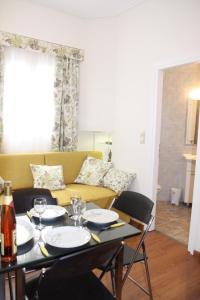 アテネにあるBe My Guest Apartmentのダイニングルームテーブル(椅子付)、黄色のソファ