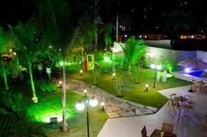 a garden at night with lights in a park at Flats Futuro Prince Prime in Recife