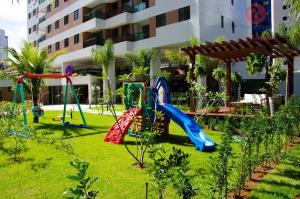 a playground with a slide in a yard at Flats Futuro Prince Prime in Recife