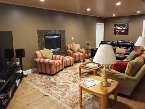 a large living room with couches and a fireplace at Elegant 2 King Bedrooms Apartment - 4 guest maximum and2 night minimum in Traverse City