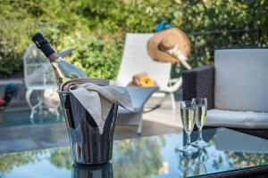 a glass table with a bottle of champagne and two glasses at Sweet Tuscany Appartamento Gold in Arezzo +18 photos