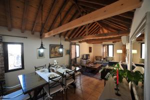 a dining room with a table and a living room at Cathedral Suite in Toledo