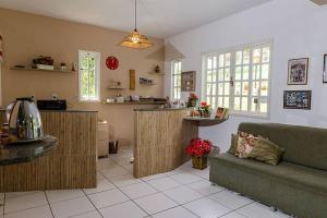 a living room with a couch and a kitchen at Itaporanga Pousada in Santa Maria Madalena