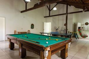 a pool table with balls on it in a room at Itaporanga Pousada in Santa Maria Madalena