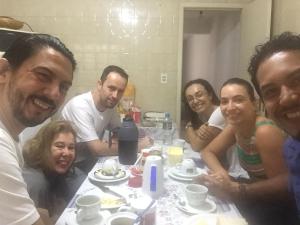 a group of people sitting around a table at Pousada Family Consulado Americano in São Paulo