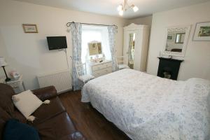 a bedroom with a bed and a couch at Southford House (Room Only) in Dartmouth