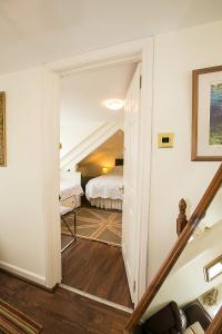 a hallway leading to a bedroom with a bed at Southford House (Room Only) in Dartmouth