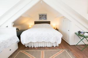 a bedroom with a white bed in a attic at Southford House (Room Only) in Dartmouth