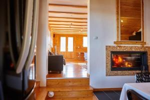 a living room with a fireplace in a house at Méribel Chalet Merveilleux in Les Allues