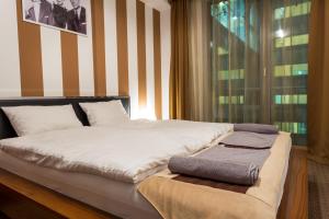 Giường trong phòng chung tại Cityhome Downtown Suites & Spa
