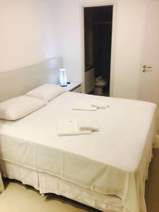 Ένα ή περισσότερα κρεβάτια σε δωμάτιο στο Flats Rosarinho Prince Residence