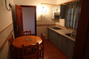 a kitchen with a wooden table and a kitchen with a sink at Casas La Torre in Isora