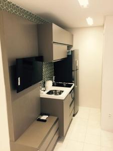a small kitchen with a stove and a refrigerator at Flats Jaqueira Prime in Recife
