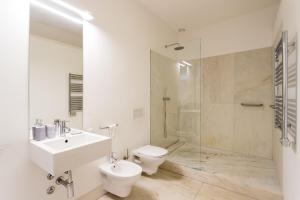 a bathroom with a sink and a toilet and a shower at Chiado Cozy Apartments - by LU Holidays in Lisbon +25 photos