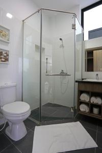 a bathroom with a shower with a toilet and a sink at Eco Garden Residences in Phnom Penh
