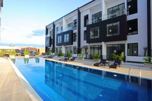a large swimming pool in front of a building at Eco Garden Residences in Phnom Penh