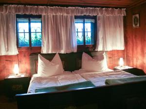 a bedroom with a large bed with two windows at Ferienhaus Nelln in Reith