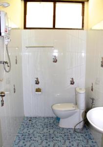 a bathroom with a toilet and a sink at Fruit Tree Lodge in Ko Lanta