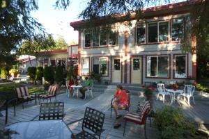 people sitting on a patio in front of a building at Black Bear Inn in Ketchikan
