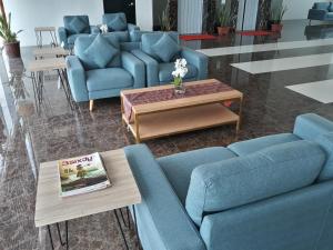 a living room with blue couches and a coffee table at YBC Grand Hotel in Olongapo