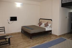 Postel nebo postele na pokoji v ubytování Hotel Jaidharshini Palace