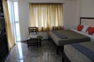 Postel nebo postele na pokoji v ubytování Hotel Jaidharshini Palace