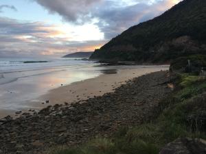 a rocky shoreline overlooking the ocean at Cumberland River Holiday Park in Lorne