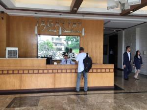 a man standing at the counter of a restaurant at Cityland Jane's Apartment in Tagaytay