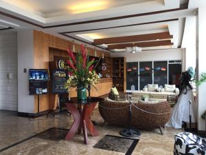 a lobby with a table with a vase of flowers on it at Cityland Jane's Apartment in Tagaytay