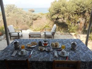 a table with a blue table cloth with food on it at Longo Vezo in Anakao