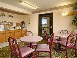 a room with two tables and chairs and a kitchen at Days Inn by Wyndham Mexico in Mexico