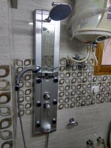 a shower in a bathroom with a mirror at Shimla Facing Rooms Near Mall Road in Shimla