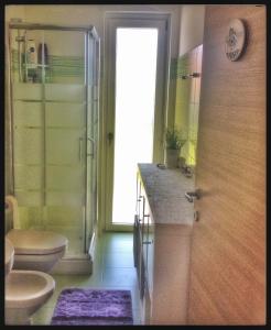 a bathroom with a toilet and a sink and a shower at Il riposo dei Giganti in Càbras