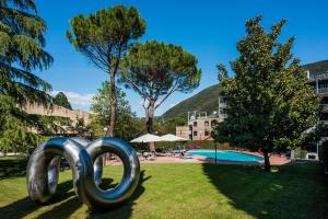 a sculpture of a chain in front of a pool at Albornoz Palace Hotel in Spoleto