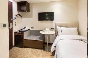 Postel nebo postele na pokoji v ubytování K Hotel Tianjin