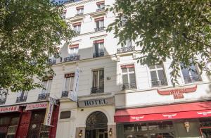 a large white building with a hotel at Hotel Paris Bruxelles in Paris