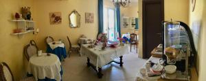 a dining room with two tables and a mirror at Hotel Scilla in Scilla