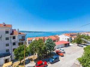 a view of a city with cars parked in a parking lot at Apartments Ankica in Crikvenica