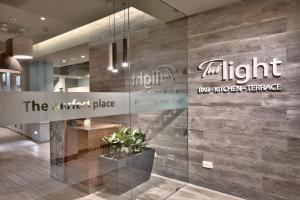 a lobby with a wall with the light sign on it at Luna Holiday Complex in Mellieħa