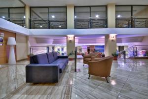 a lobby with couches and chairs in a building at Luna Holiday Complex in Mellieħa