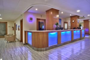 a hospital lobby with a bar with blue lights at Luna Holiday Complex in Mellieħa